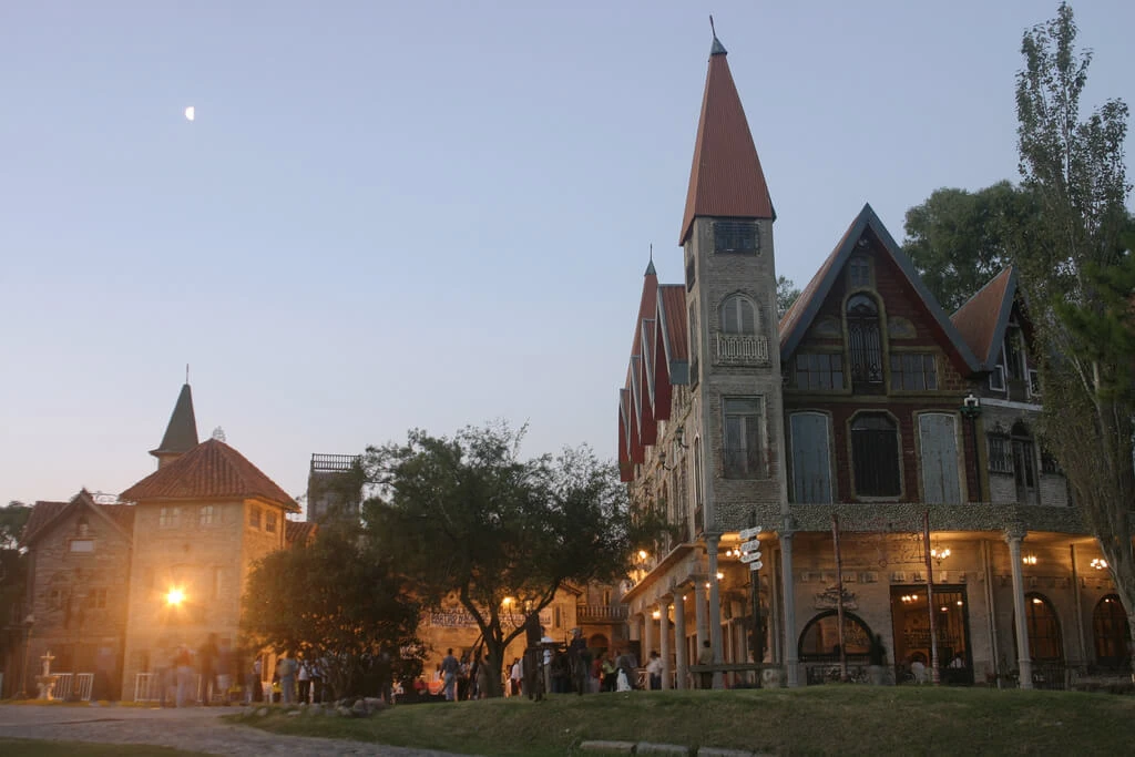 Edificios medievales de colores con iglesia al atardecer en pueblo histórico