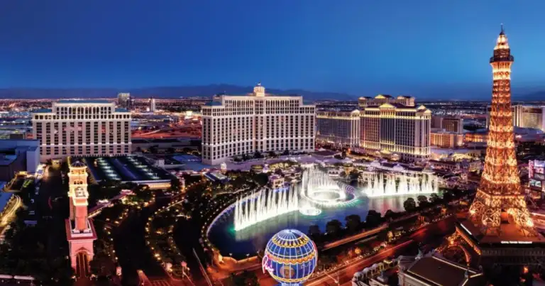 Vista aérea de Las Vegas iluminada al atardecer con casinos y la Torre Eiffel