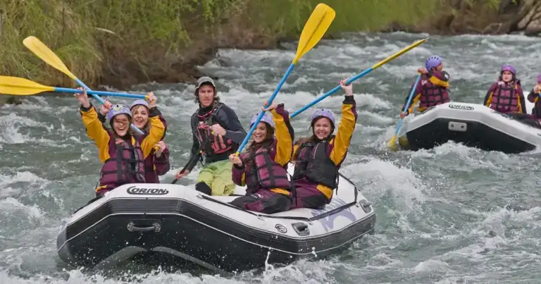 Grupo de personas en bote de rafting en aguas rápidas