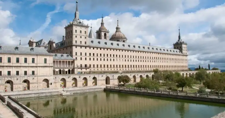 Monasterio del Escorial, complejo arquitectónico renacentista con torres y estanque frontal