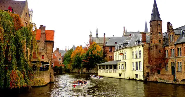 Canales de Brujas con edificios medievales y barcos pequeños en el agua