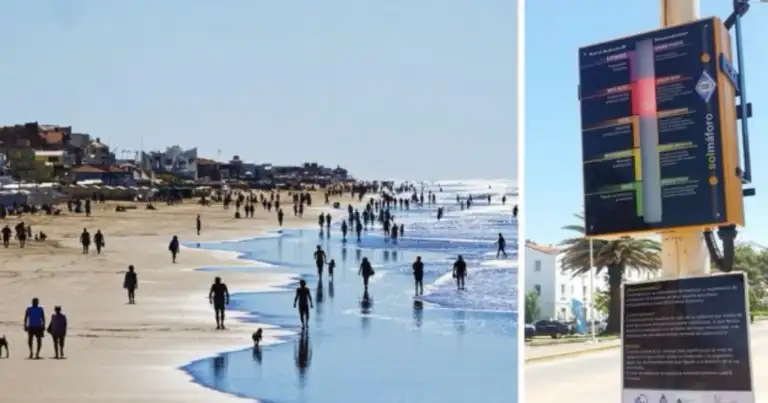 Playa con visitantes y un semáforo de arena en la costa