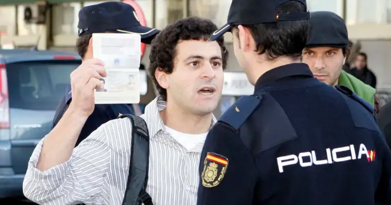 Hombre mostrando pasaporte a oficiales de migración