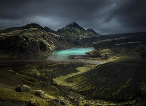Tierras altas del sur de Islandia con lago turquesa y montañas volcánicas