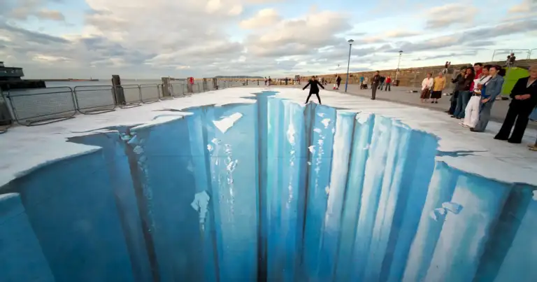 Ilusión 3D anamórfica de acantilado de hielo en pavimento