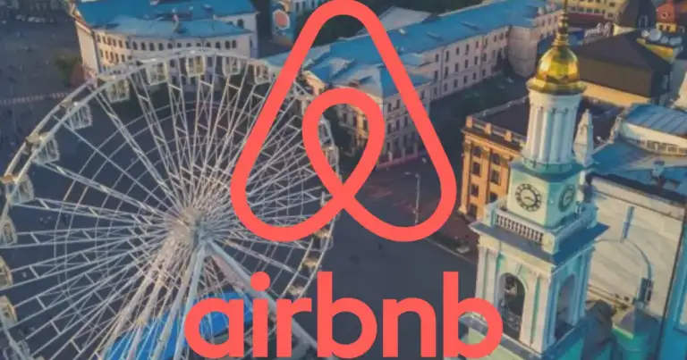 Skyline urbano con rueda de observación y logo rojo de Airbnb