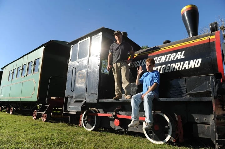 Tren histórico verde y negro con cartel Central Entrerriano, personas subiendo