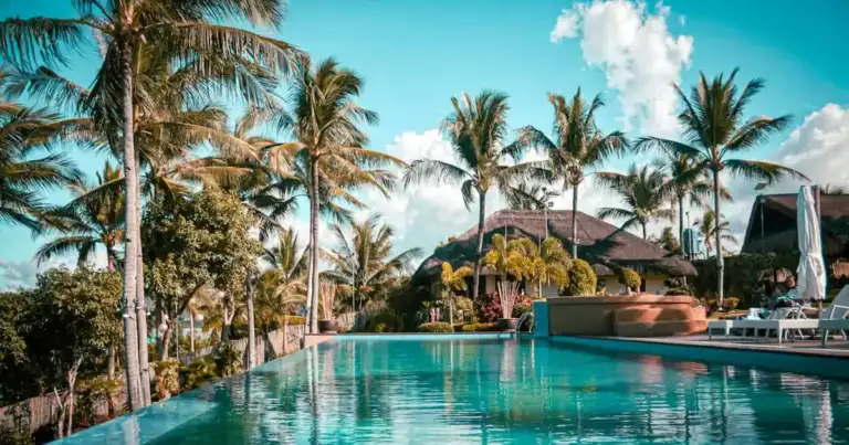 Resort de lujo con piscina infinita, palmeras y vista tropical, una imagen que representa los hoteles más caros del mundo en 2026 y las experiencias exclusivas de alto nivel.