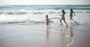 Familia disfruta de la playa durante unas vacaciones de verano junto al mar